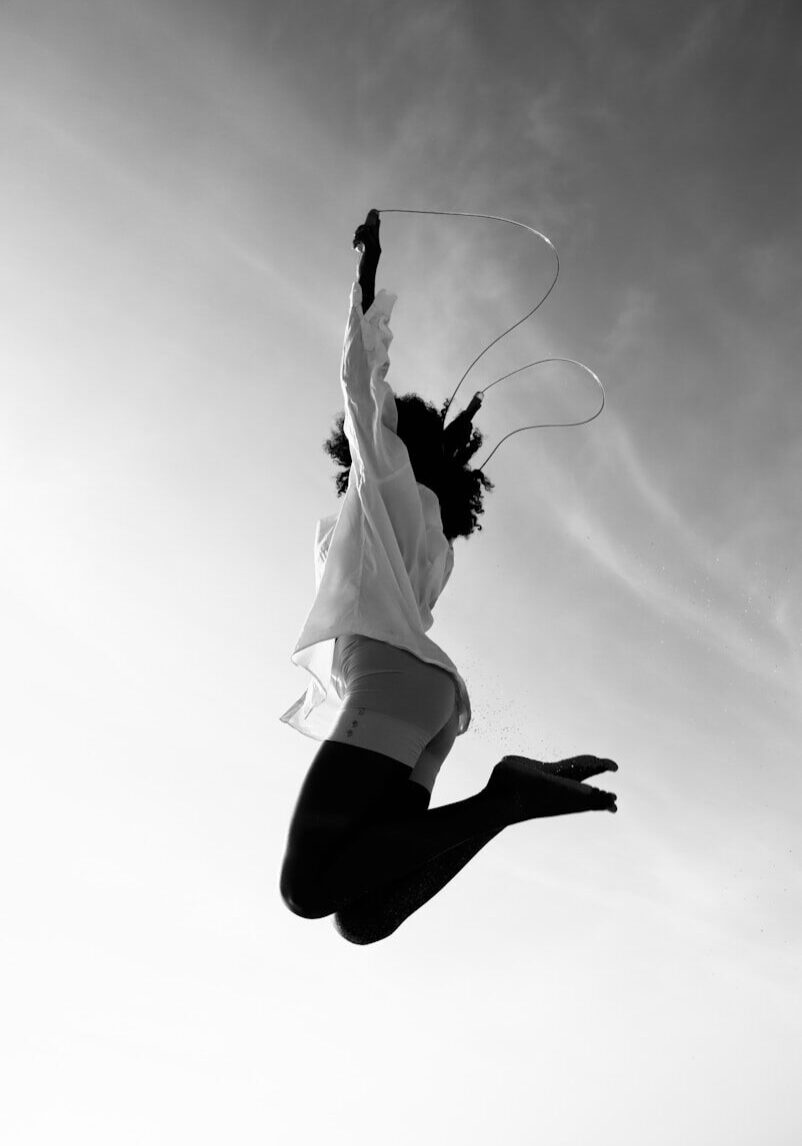 a man flying through the air while riding a kite