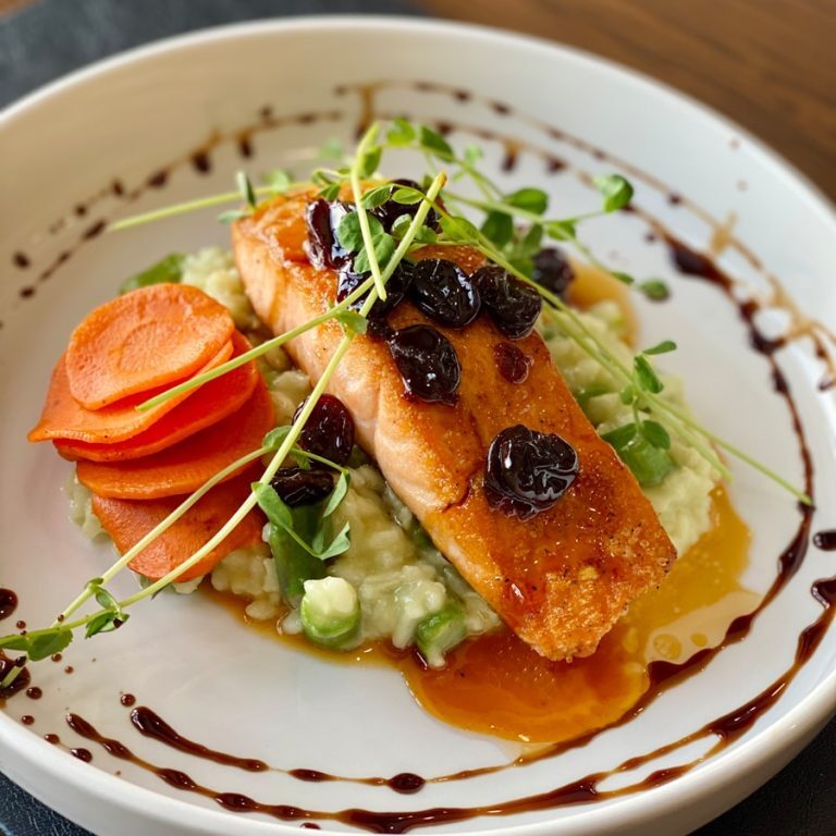 a white plate topped with fish and veggies